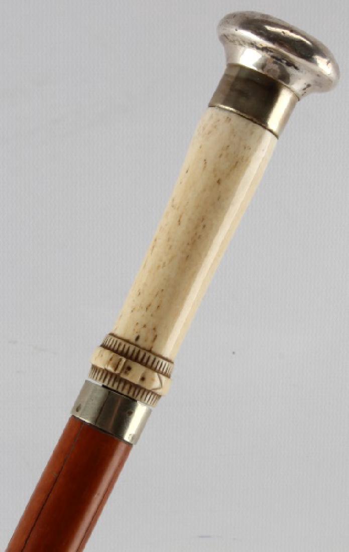 ANTIQUE BONE GRIP & STERLING SWORD WALKING CANE: Nice blued and etched blade, monogrammed top in sterling, nicely patinated light to dark wood shaft, original ferrule tip, measures 34.5 inches. Face, Dial, Hands: john This lot has a reserve.