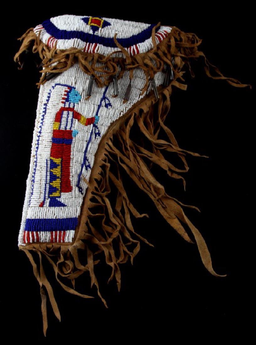 AUTHENTIC SIOUX INDIAN LEATHER BEADED GUN HOLSTER: 12 inch Sioux Indian Pictorial Beaded Gun Holster, left side. It is in good condition, appears to be brain tanned leather and beadwork and fringe are in good condition. It has been shaped and has meta