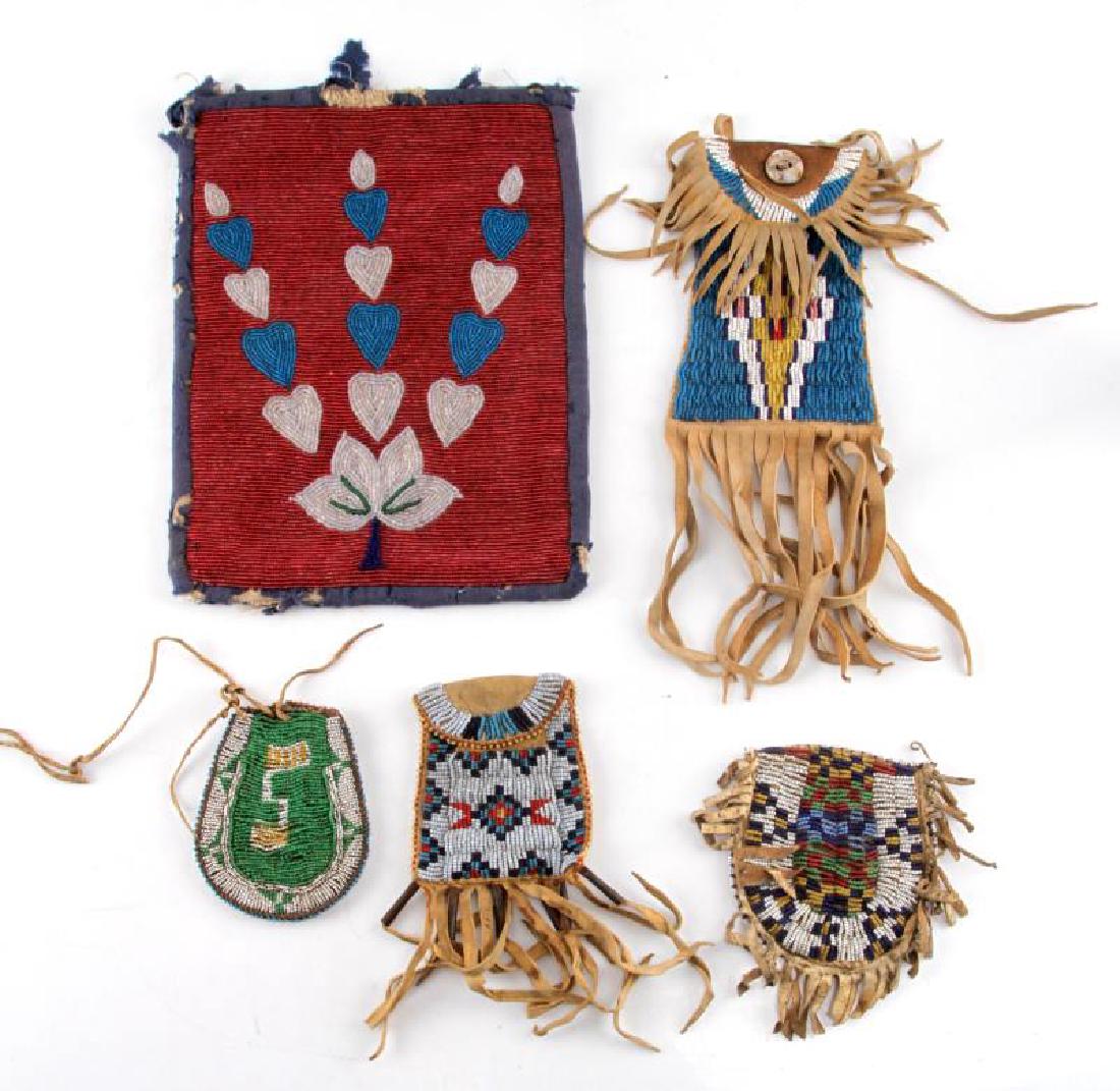 ANTIQUE NATIVE AMERICAN BEADED LEATHER BAG LOT: Lot consists of 5 antique medicine-tobacco beaded leather bags of various sizes each showing some wear and discoloration with beadwork intact. The large bag has some fabric loss around edges and is co