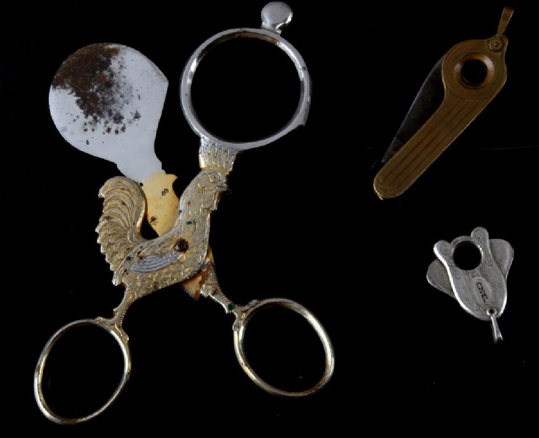 ANTIQUE CIGAR CUTTER VARIETY COLLECTION LOT OF 3: 3 Antique cigar cutters of varied design and function. 1 is a large scissor style cigar cutter with the handle shaped like a rooster, gold plated. Measures 5 1/2 inches long. 1 is a folding knife styl