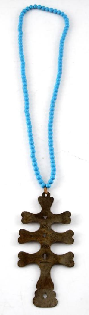 ANTIQUE FUR TRADE NATIVE AMERICAN CROSS AND BEADS: Fur trade cross with trade beads on the necklace. Cross is stamped with a wolf symbol, "WE", and Montreal. Cross is 6 1/2 inches in height. In very good condition with some tarnish. Unauthenticated/So