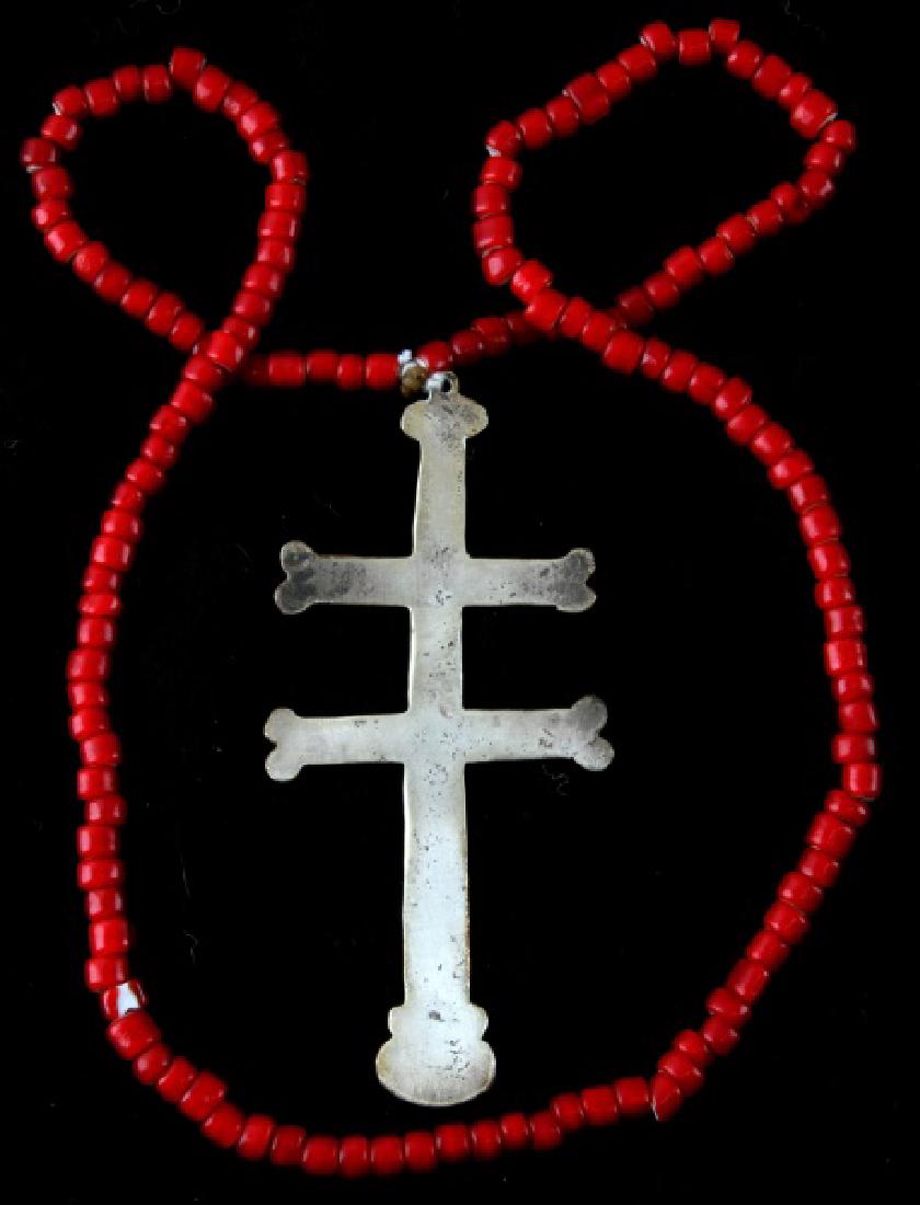 NATIVE AMERICAN ANTIQUE FUR TRADE SILVER CROSS: Silver two-barred Cross of Lorraine from the fur trade with Native Americans. No visible maker's marks or hallmarks, 4 1/2 inches in length with a red Venetian bead necklace that is original to the sa