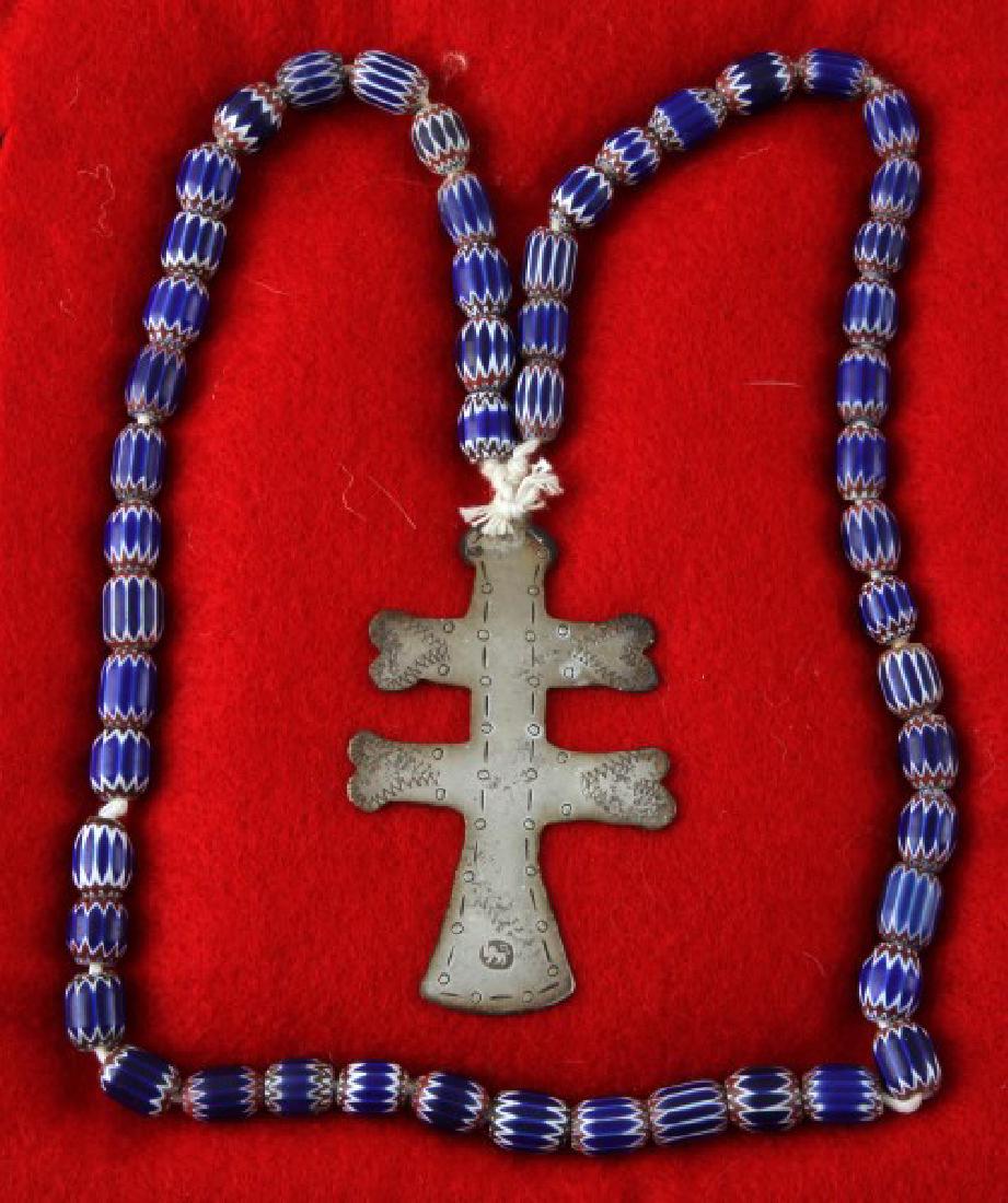 ANTIQUE NATIVE AMERICAN FUR TRADE SILVER CROSS: Silver two-barred Cross of Lorraine from the fur trade with Native Americans. It has a hallmark consisting of a lion passant facing left with a sword in its upraised paw, 2 3/4 inches in length, and g