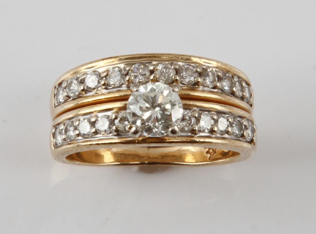 14KT YELLOW GOLD AND DIAMOND DBL BAND RING .96 TCW: 14KT yellow gold and diamond double band wedding ring. Size 4.5. Weigh 5.3 grams. Round cut center stone measures 4.5 by 4.5mm with VVS2 clarity and I-J color. The surrounding 21 round cut diamonds me