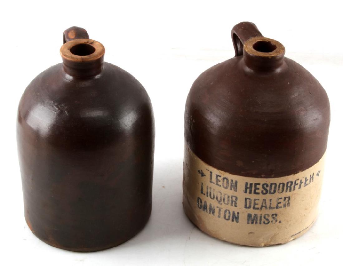 ANTIQUE RUSTIC WHISKEY & WATER STONEWARE CROCKS: Lot of 3 includes 2 whiskey jugs each 9 inches in height with 6 inch diameters, one has advertising stamp that reads Leon Hesdorffer Liuqor ( yes it is miss spelled on bottle) Dealer Canton Miss. The 