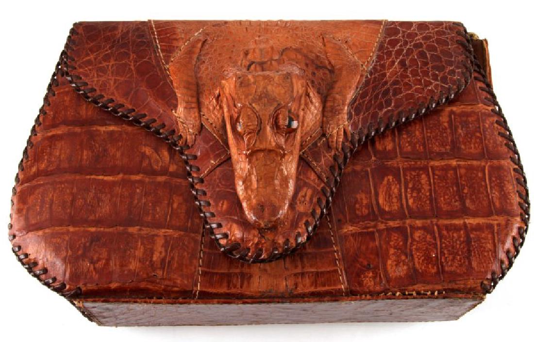VINTAGE MID CENTURY CUBAN MADE ALLIGATOR PURSE: Exterior displays a juvenile alligator head with body. Interior marked "Real Alligator Made in Cuba". Strap is torn. Good condition. Interior pouch zipper is functional. Measures approx. 11"x7"x2".
