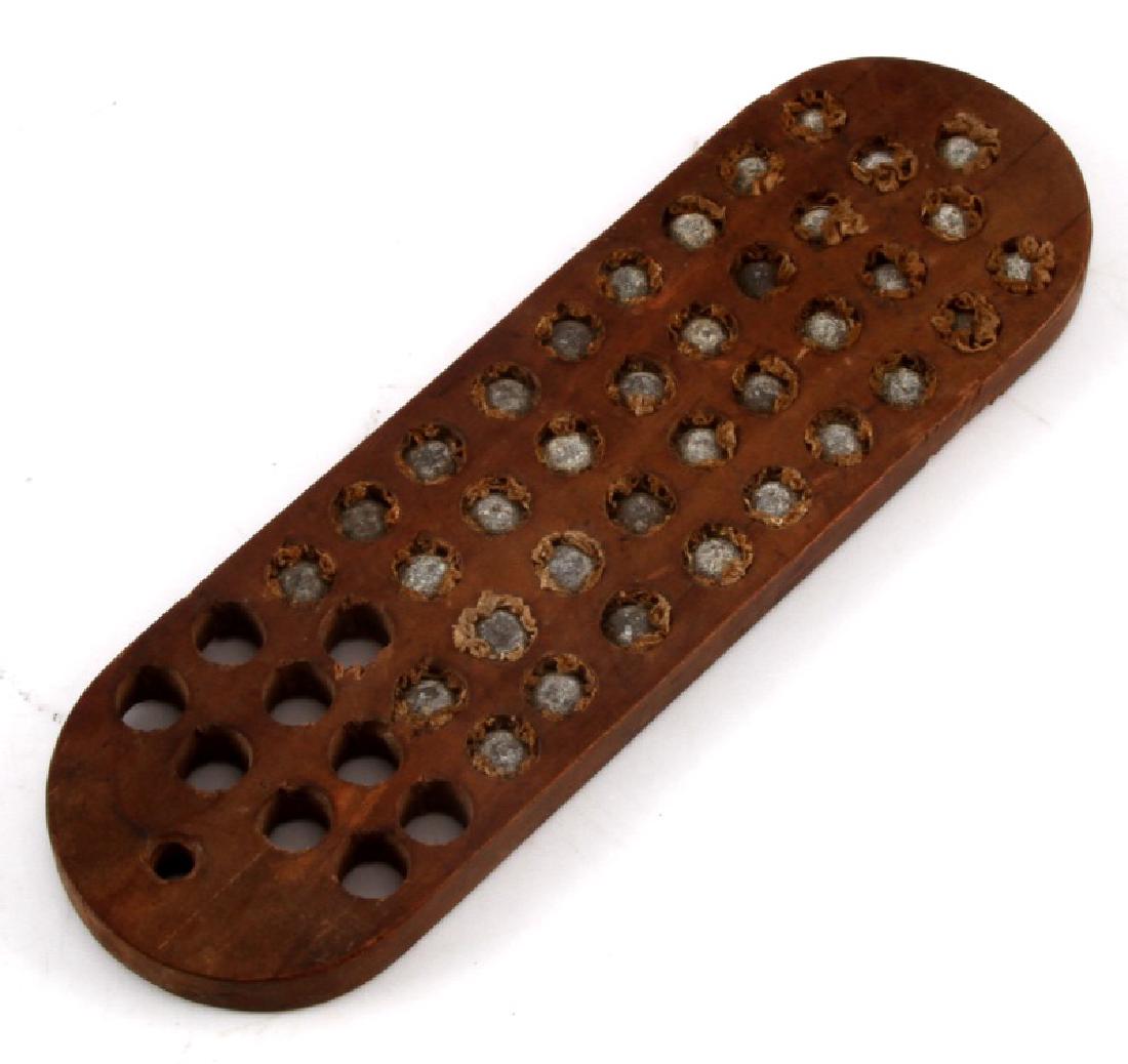 ANTIQUE WOODEN BULLET BLOCK: Measures 7" x 2 1/4". Many bullets still in holes. Wood block in very good condition, no splitting. A great piece for collectors. Comes in riker mount display case.