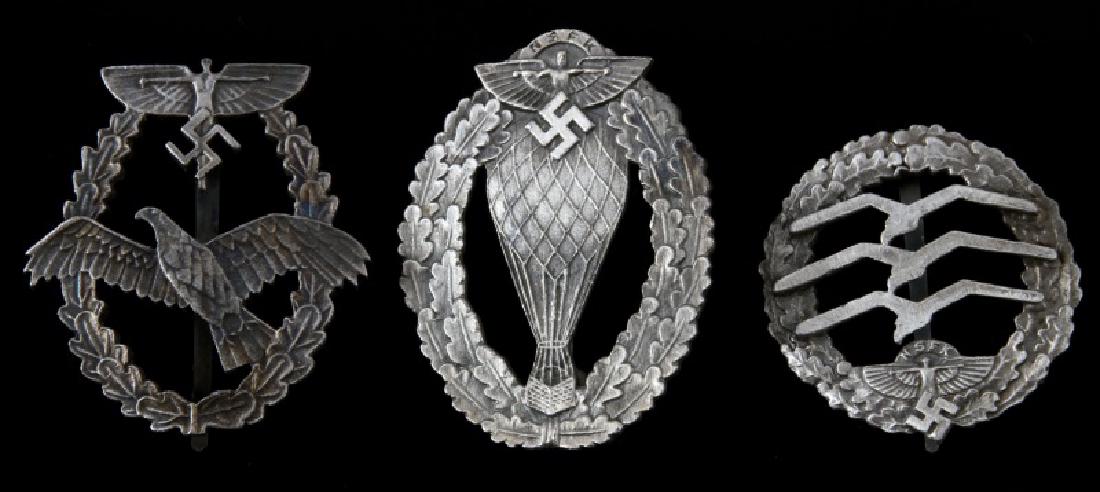 3 GERMAN WWII THIRD REICH NSFK BADGES: Includes Glider Pilot, Balloon Pilot, and Pilot. Some wear and discoloring present. Overall in very good condition. Unauthenticated, sold as is. This lot has a reserve.