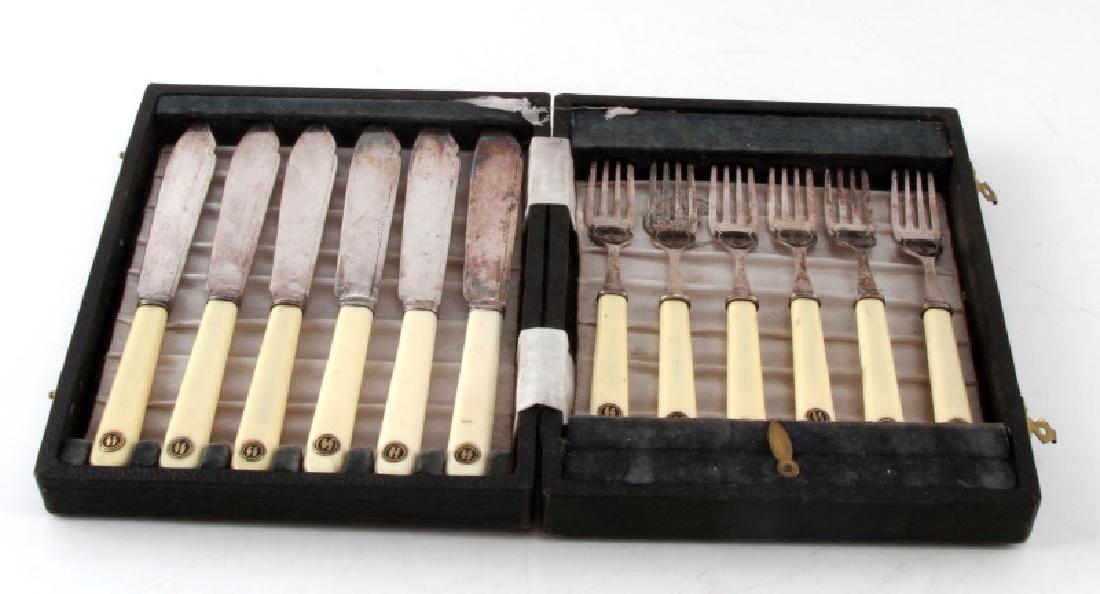 12 PC WWII GERMAN SS FORK & KNIFE DINNERWARE SET: Antique 12 piece set of SS cutlery (6 forks/6 knives) in wooden box. Age wear and patina present. Small chips to a few handles. Basic engraved design around edges. "F&W Ltd. EPNS" and "EPNS A1" marks.