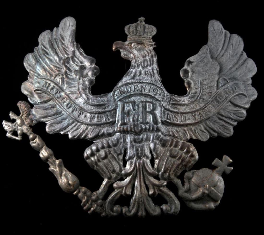 WWI IMPERIAL GERMAN BAVARIAN EM HELMET FRONT PLATE: Measures 5 1/4 inches wide by 4 1/2 inches tall. Stamped steel construction for an enlisted man. Two loops on the reverse for securing to helmet. Unauthenticated sold as is.