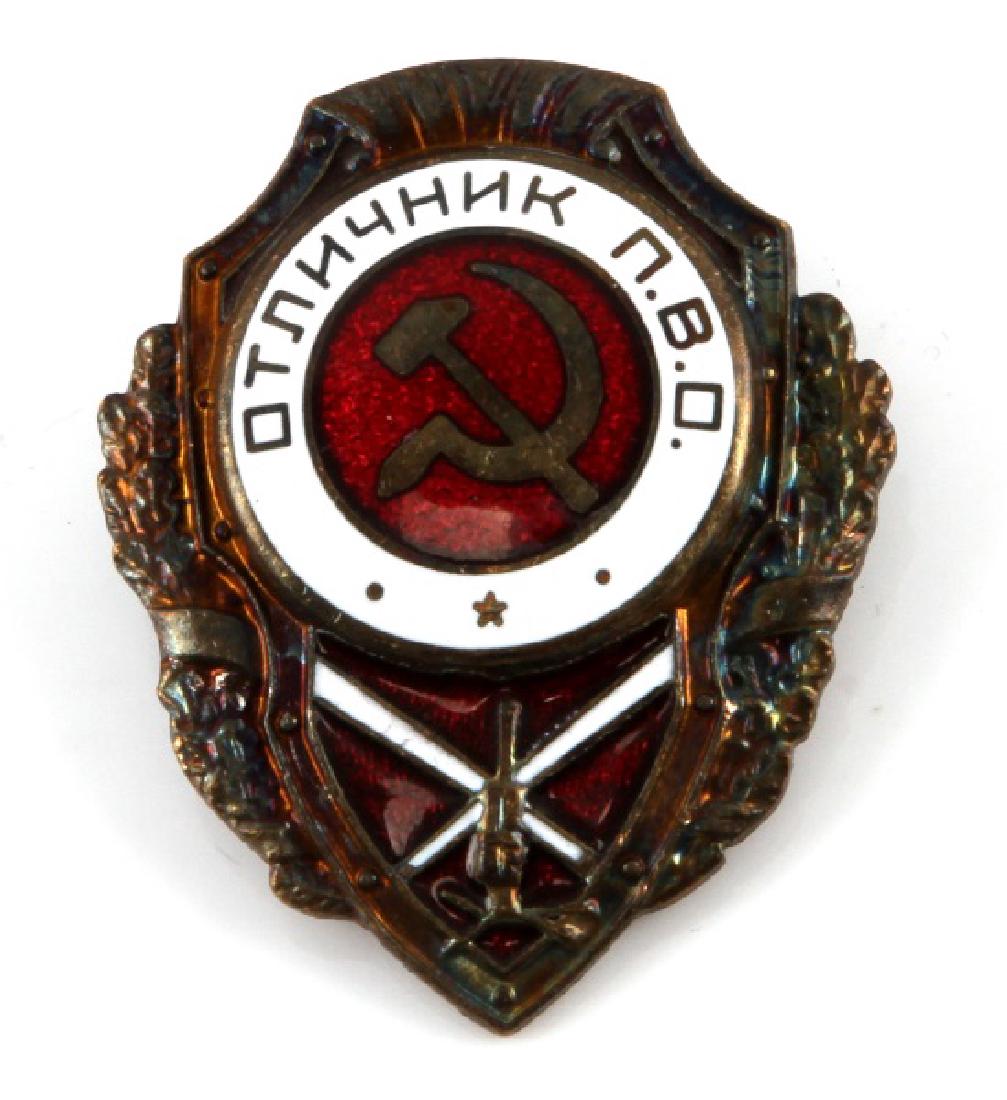 WWII SOVIET RUSSIAN RED ARMY FLAK ARTILLERY BADGE: Measures 1 1/2 inches wide by 1 7/8 inches tall. Has an enameled hammer & sickle in the center with a tank below. Has a screw mount post and nut on the reverse. The brass nut is maker marked 'MHAbERHA