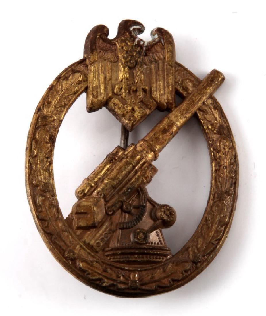 GERMAN WWII THIRD REICH ARMY FLAK ARTILLERY BADGE: Measures approx. 2 3/8 inches. Reverse side is maker marked 'C E Junker Berlin SW 68'. Thin vertical T-bar style pin back with 180 degree pin lie. Nickel construction. Heavy age wear/tarnish present.