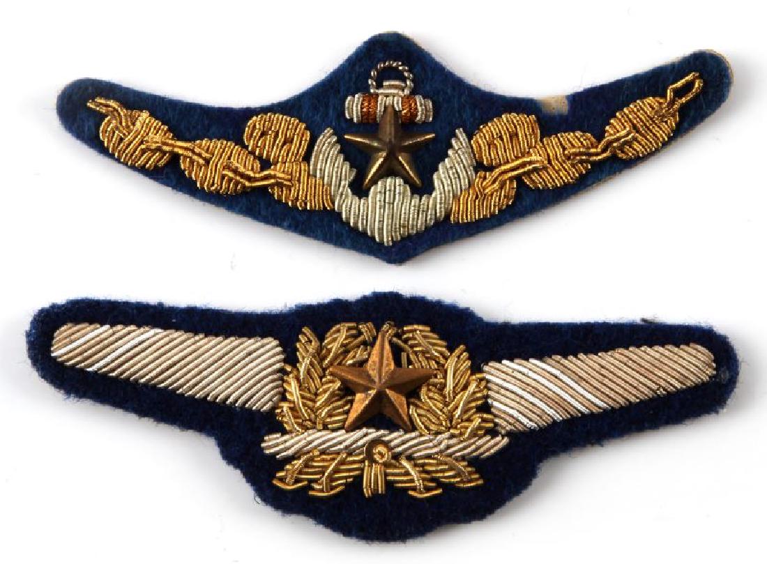 2 JAPANESE WWII AVIATOR BULLION PILOT WING LOT: Lot of two (2) - one Army and one Naval. Army one measures 3 3/4 inches x 1 1/8 inches . Naval one measures 3 1/8 inches x 1 1 /16 inches. Each has silver and gold bullion wire embroidered on dark blu