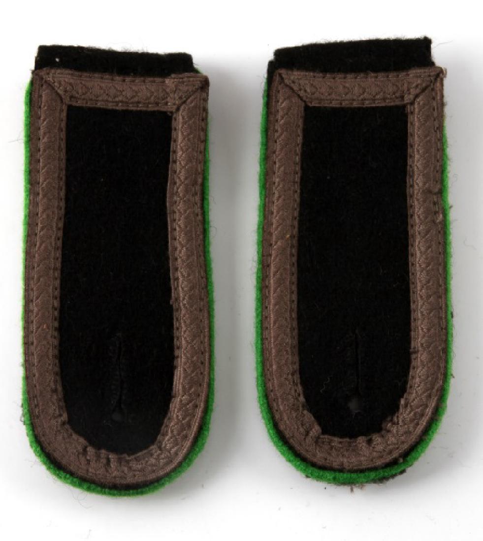 WWII SS PANZER GRENADIER NCO SHOULDER BOARDS: Pair of German WWII Waffen SS Panzer Grenadier NCO shoulder boards. They measure 1 7/8" wide by 8" long. Has NCO tresses sewn around the edge sewn on a black wool background. Displays green piping. Sl