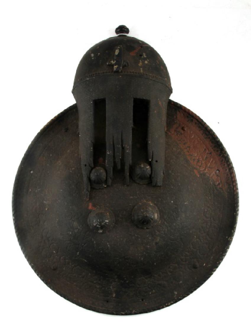 ANGLO SAXON SHIELD & HELMET WALL ART PUB SIGN: Cast iron hanging wall art depicting a shield and stylized helmet in what appears to be an Anglo-Saxon homage. Possibly a sign. Measures 17 1/4 inches across by 23 inches tall. Believed a pub or busin