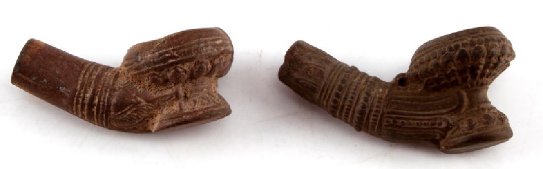 2 ANTIQUE NATIVE AMERICAN ORNATE CLAY PIPE LOT: Each measures approx. 2 1/2" each. No markings. Both pipes ornately designed all over and in very nice condition. Come displayed in small riker mount case.