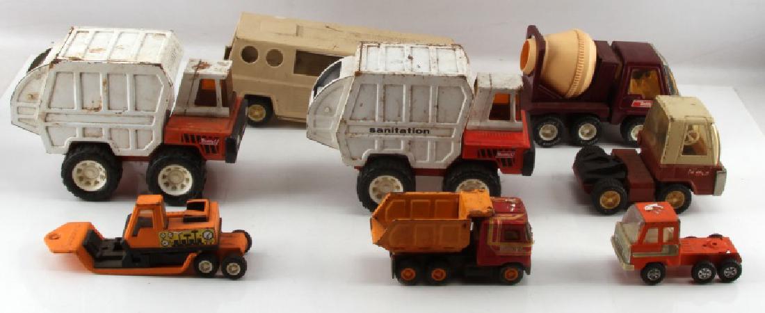 JAPANESE BUDDY L DIE CAST MODEL TRUCK LOT OF 6: 6 model trucks from Japanese toy maker Buddy L. 2 Sanitation trucks, measuring 10 inches and with some wear on the paint. 1 dump truck measuring 6 inches. 1 tractor and horse trailer, measuring 15 inc