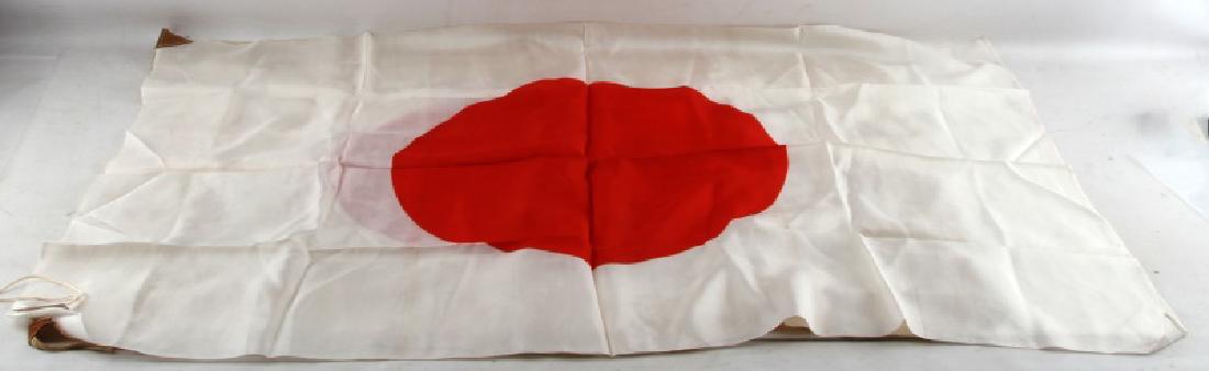 LOT OF 2 WWII JAPANESE MILITARY MEATBALL FLAGS: Grouping of 2 WWII Imperial Japanese Military meatball flags made of silk with corner cut leather fastening ties. First flag measures 26 inches by 32.5 inches, second flag measures 27 inches by 39 inc