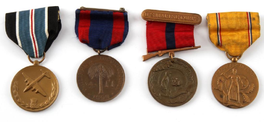 4 ASSORTED US MILITARY SERVICE MEDAL LOT: Medal for Human Action (Berlin Airlift), USMC Officer "Good Conduct" medal, US Army "1899 Philippine Insurrection" service medal, and "American Defense" service medal. Some age wear present. All in ve