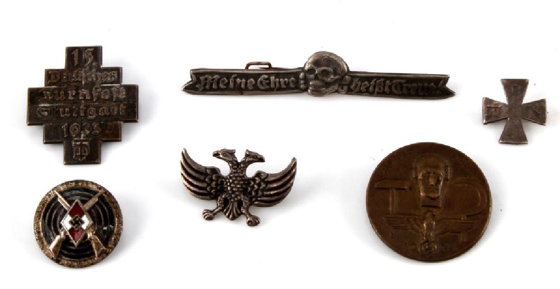 6 ASSORTED GERMAN WWII THIRD REICH BADGES LOT: Lot of six (6) includes: "Tag Der Arbeit", Iron Cross and more. Age wear present. Maker marks. All in very good condition. Unauthenticated. Sold "as is".