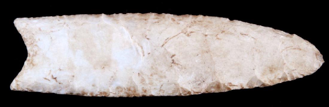 LATE PALEOLITHIC HAND CLEAVED LITHIC SPEAR BLADE: Paleolithic South American found spear or knife blade. Measures 5 1/4 inches in length with a cleaved pommel with two protruding points for fastening. Cleaved from a mostly homogenous white lithic sto
