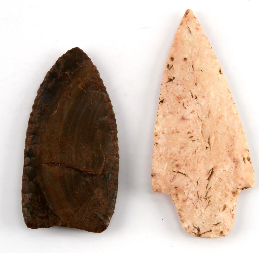 PAIR OF LATE PALEOLITHIC ERA CLEAVED ARROW POINTS: Late Paleolithic Era Hand Cleaved Arrow points the first of which is made of a semi - homogenous metamorphic stone which is an off - white color with black & brown flecks, and is fashioned in the trad
