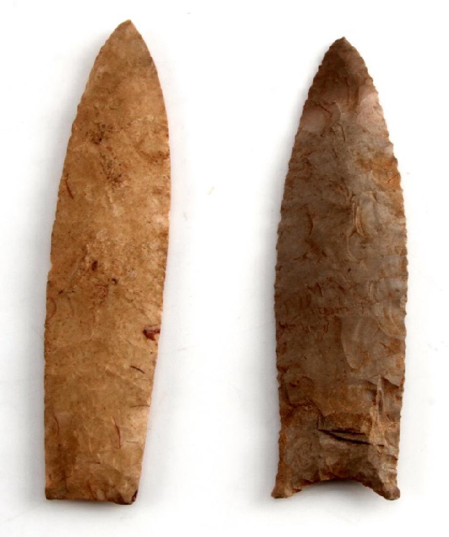 NATIVE AMERICAN CARVED CHERT ARROWHEAD LOT OF 2: The first is a 6 inch Angostura point from the early Archaic period carved from a beige chert; has a smooth horizontal transverse flaking pattern. The other is an auriculate Clovis point from the Pale