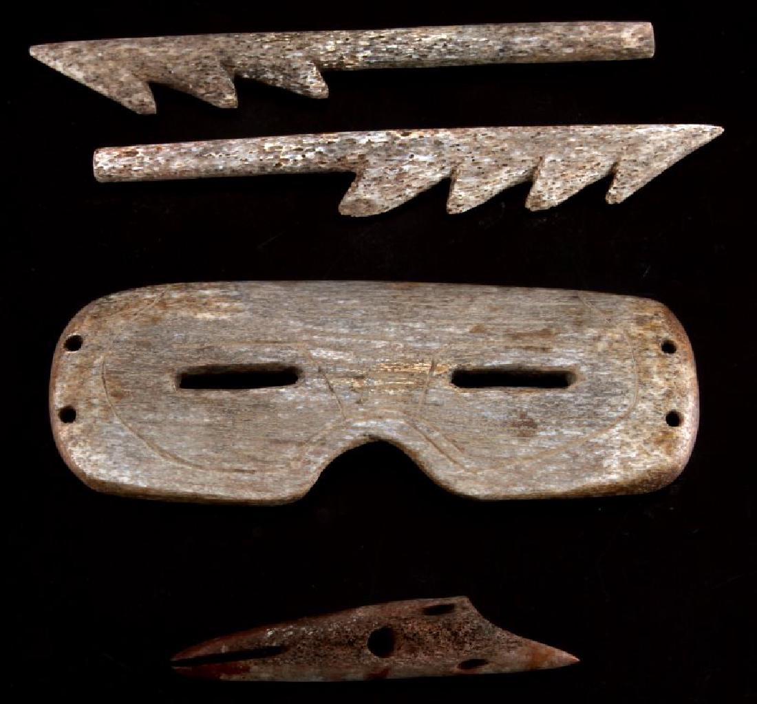 ANTIQUE INUIT WHALE BONE HARPOON AND GOGGLES: lot of 4 includes 3 harpoon tips, 2 are 6 inches long and the third measures3 3/4 inches. Fourth item, whale bone goggles are 6 by 2 1/8 inches.