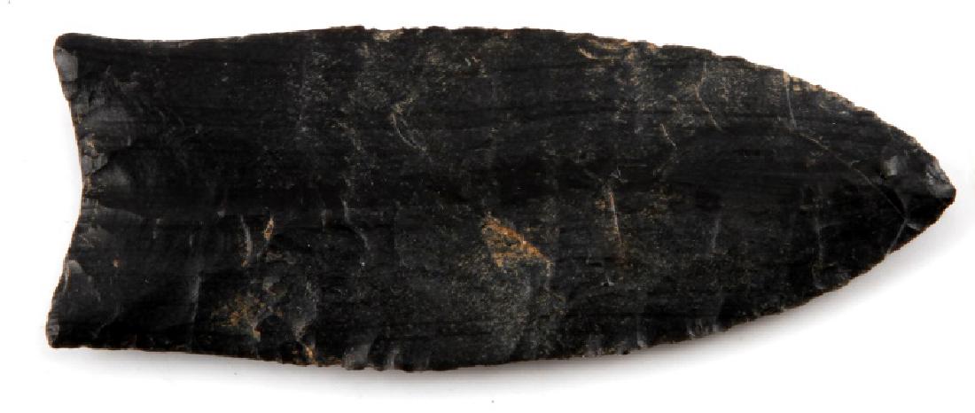PALEO CLOVIS ARROWHEAD POINT OHIO WITH COA 3 INCH: Charcoal color, made of Upper Mercer flint, grade 10, measures 3 inches long. Exceptional parallel flaking with some haft marks to bottom. Worn patina. Very good condition. Comes with COA from T&T Arc