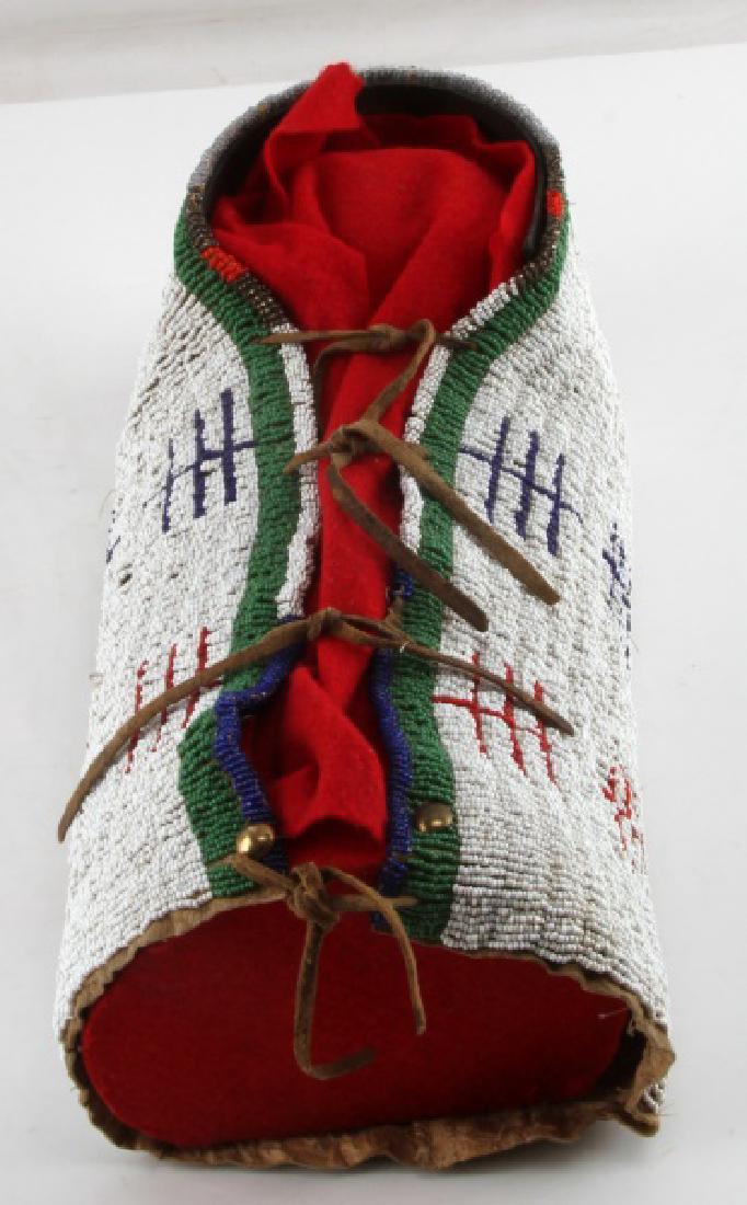 NATIVE AMERICAN SWADDLE BEADED CHILDREN'S CRADLE: Antique Native American beaded genuine leather hide swaddle or cradle. Cradle or swaddle is made of a hard sturdy genuine leather hide which has been nearly entirely beaded in white beads allowing mul