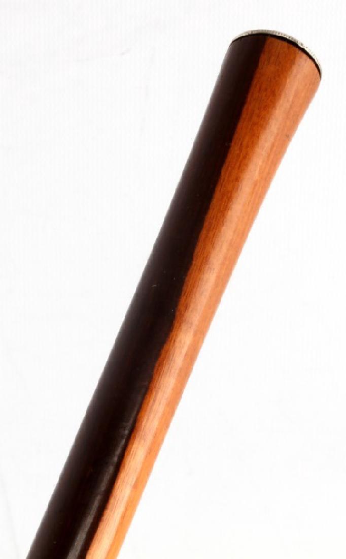 ANTIQUE WOOD WALKING STICK WITH SPANISH COIN TOP: Measures 36 inches long. In very good condition with rounded wood tip. Una peseta de Espana coin attached to the top. Light and dark brown bicolor pattern. Ex: John Montague collectionb Face, Dial, Ha