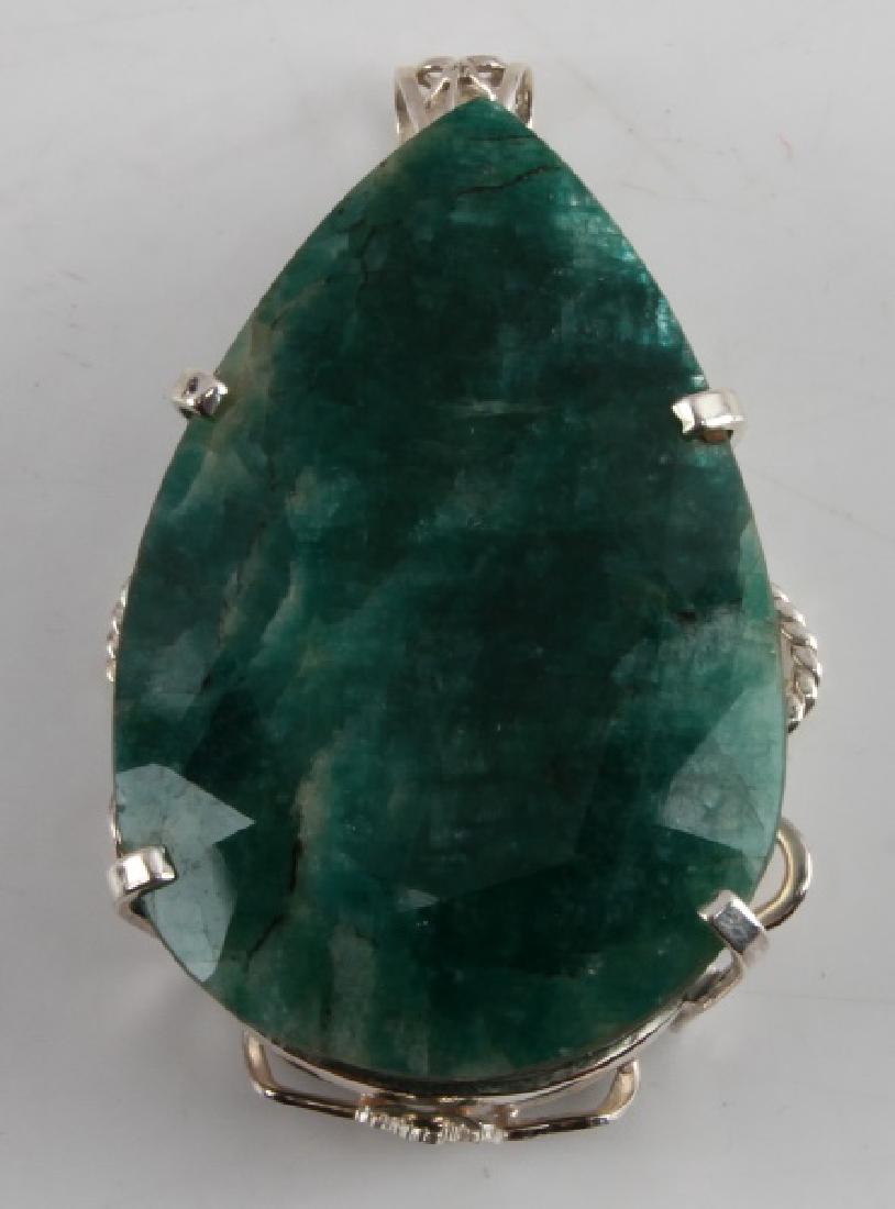 SILVER PENDANT MOUNT WITH GREEN BERYL STONE: MMTS 66.81x44.35x24.54 mm est. Carats/count 395.56 cts est. Pear shape emerald green in fair condition. GLA appraisal included.