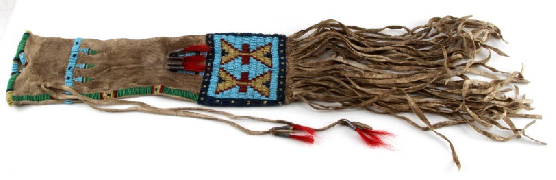 NATIVE AMERICAN BEAD LEATHER TOBACCO MEDICINE BAG: Plains Indian Two-Sided Deer Hide Bag with Fringe, late 19th c, with seed glass beadwork decoration on both sides in red, pale green and pale blue on white geometric designs. Beadwork is intact along