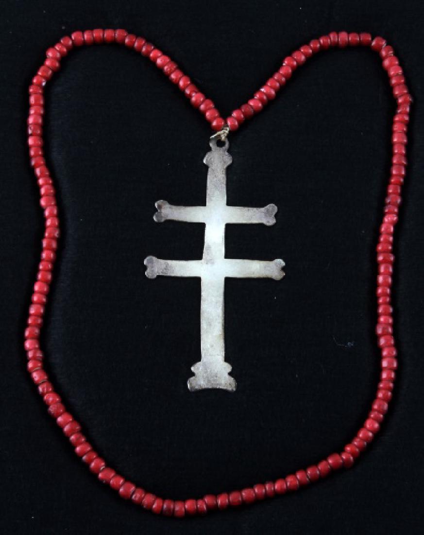 NATIVE AMERICAN ANTIQUE FUR TRADE SILVER CROSS: Silver two-barred Cross of Lorraine from the fur trade with Native Americans. There are no visible maker's marks or hallmarks, 3 3/4 inches in length, with a red Venetian bead necklace, original to th