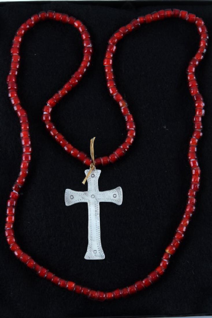 ANTIQUE NATIVE AMERICAN FUR TRADE SILVER CROSS: Silver Latin cross from the fur trade with Native Americans. No visible maker's marks or hallmarks. 3 1/2 inches in length. Has a red bead necklace which is original to the same time period, that has