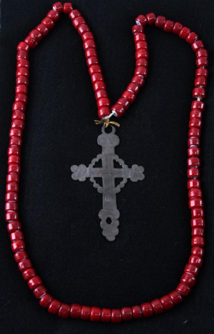 NATIVE AMERICAN ANTIQUE FUR TRADE ERA SILVER CROSS: Silver Latin cross from the fur trade with Native Americans. It bears TE maker's mark on the front of the cross and is 3 3/4 inches in length. Red bead necklace is original to the same time period but