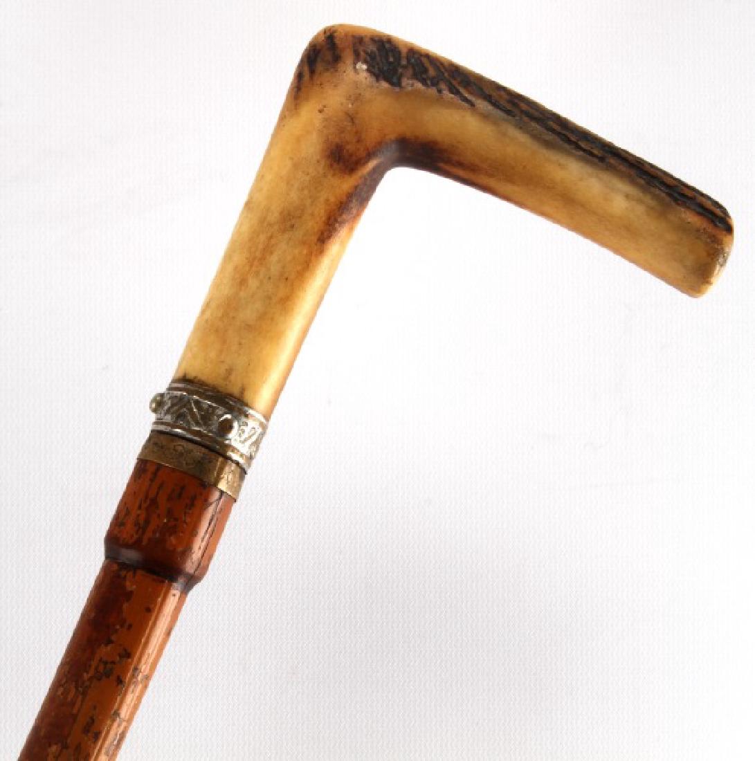 ANTLER HANDLE ANTIQUE DAGGER CANE WALKING STICK: Antique dagger cane which measures 35 1/2 inches in length. The dagger measures 17 inches in length, with the blade measuring 13 inches with a pattern of notches carved in its length. In very good con