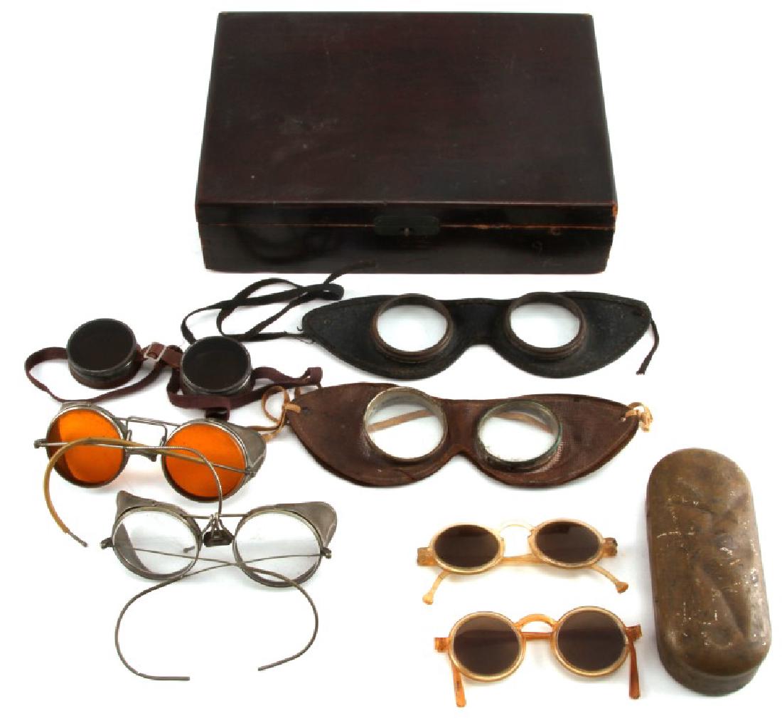 8 PIECE LOT OF ANTIQUE DRIVING & AVIATION GOGGLES: All are in very good condition except one. It is a colored pair of safety goggles and it is cracked and broke apart. The rest have good intact lenses and ear pieces. They show sign of age and wear. Th