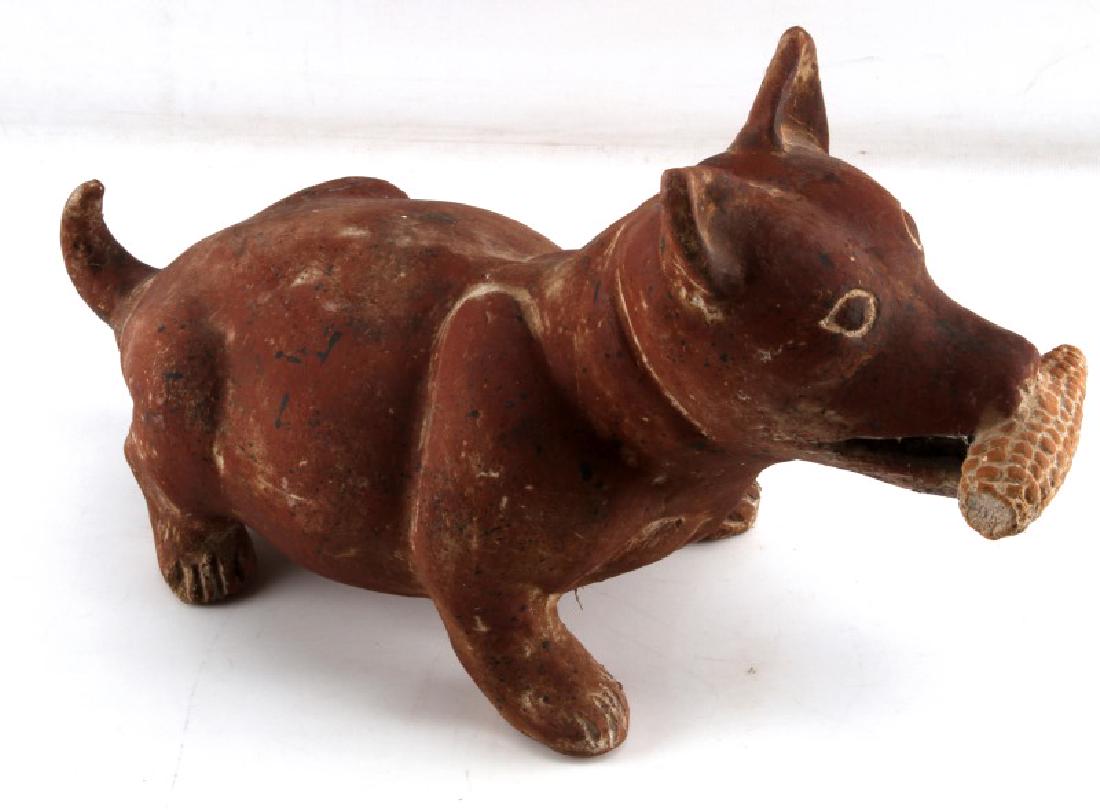 PRE COLUMBIAN COLIMA STYLE RED CLAY DOG FIGURAL: Red Clay Pottery Colima dog measures 14x9x6.5 inches and is carrying a piece of corn. In good condition with minor chipping to the paws and a hairline fissure around base of tail. Unauthenticated.