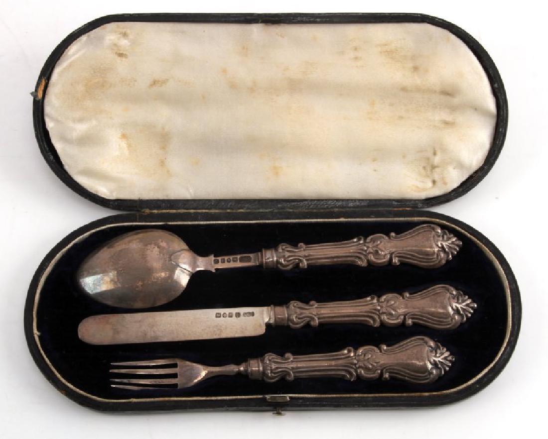 ANTIQUE ENGLISH FORMAL SILVER DINNER SET WITH CASE: Antique dinner set with case. Includes knife, fork, and spoon. Formal pattern with English origin. Silver marked and tested. Black leather case with blue felt interior. Total weight in silver: 73g. VG