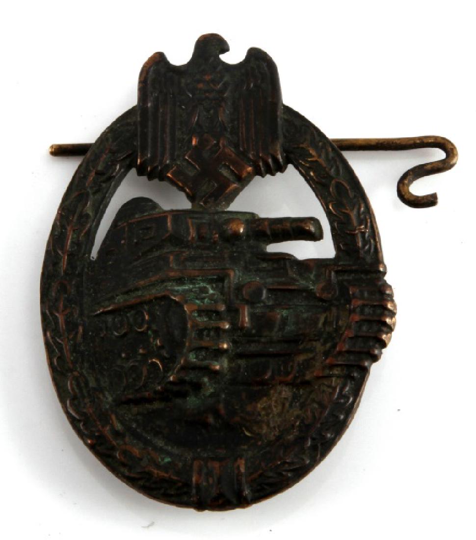 WWII GERMAN THIRD REICH PANZER ASSAULT BADGE: Bronze Panzer Assault Badge. Hollowed out back with no maker marks, and the pin has broken loose, though is still present. In fair condition, with some tarnishing of the metal.