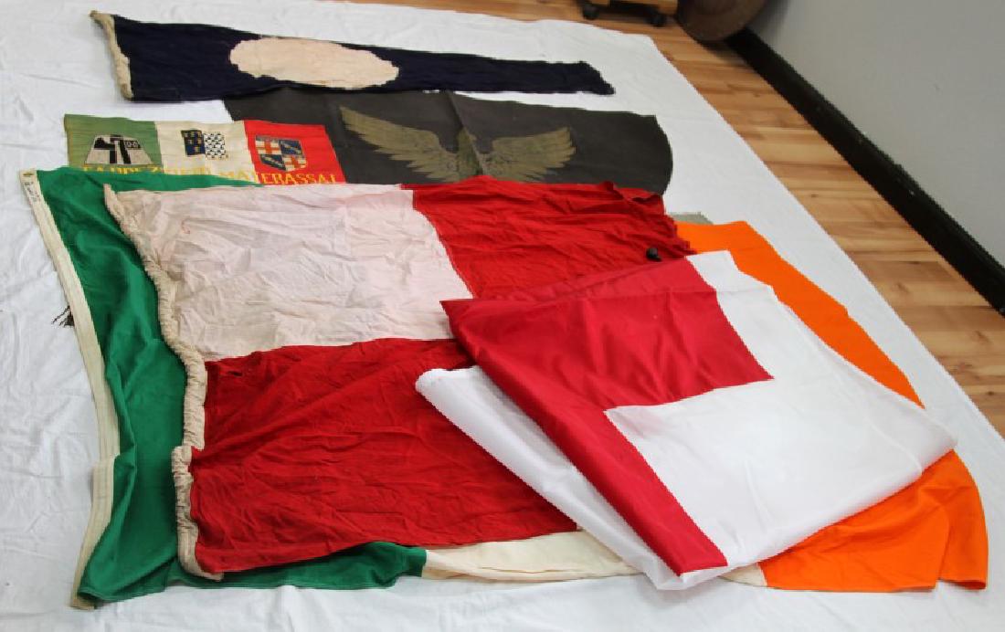 LOT OF 10 EUROPEAN AND OTHER FLAGS & BANNERS: Lot of assorted flags and banner of all sizes ages periods and regions of origin including a modern nylon Red Cross flag, vintage national flag of Ireland, large black canvas banner with Germanic Adle