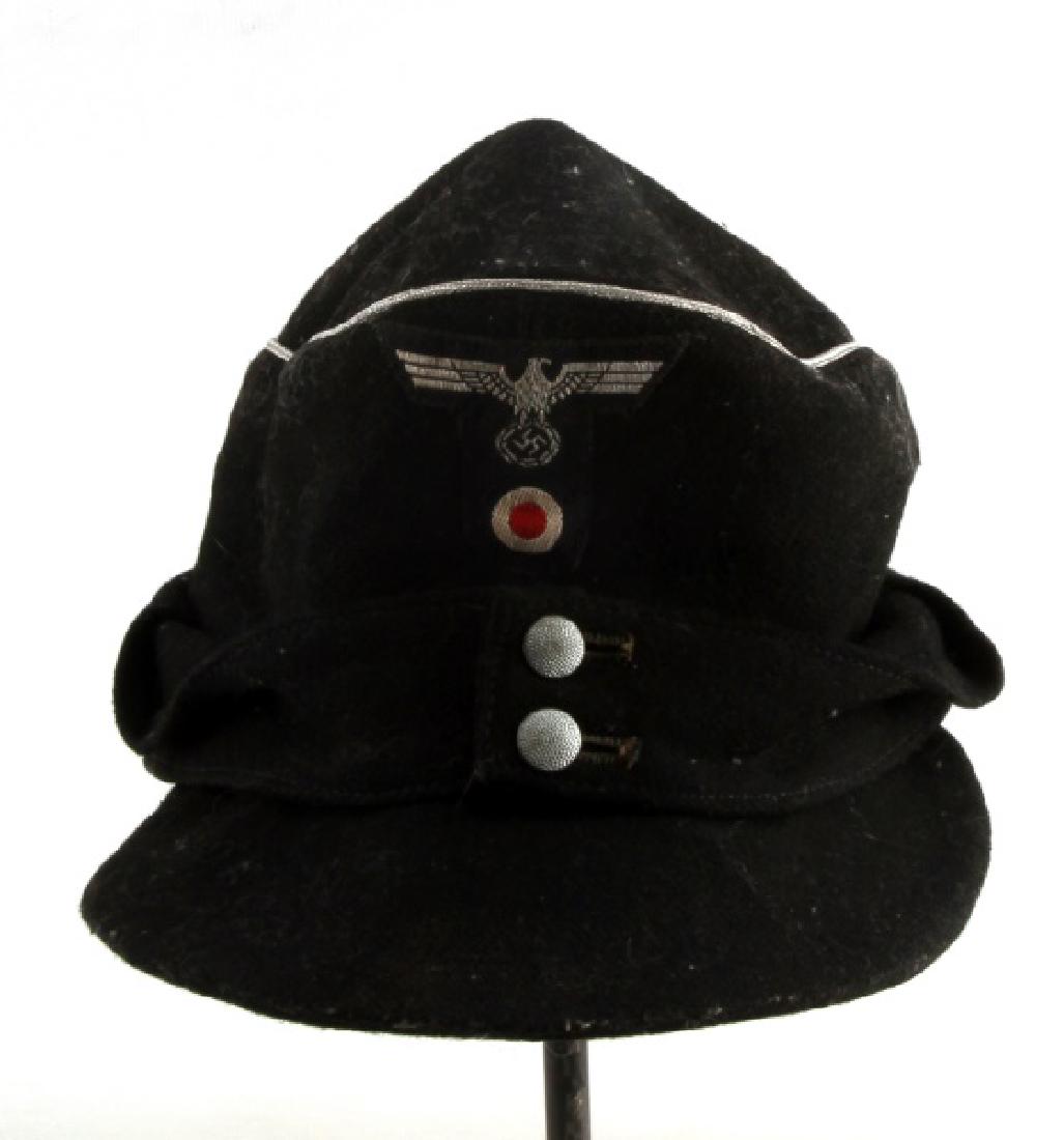 WWII GERMAN THIRD REICH BLACK M43 FIELD CAP: Black M43 field cap, has silver piping. Has a maker label on the inside. In very good condition. The cap itself passes the blacklight test, but the cockade on the front does fluoresce.