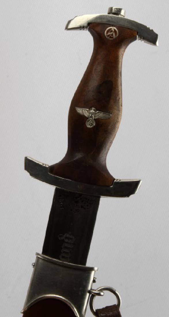 1933 WWII THIRD REICH ROHM DAGGER ERNST PACK SOHN: Complete with early SA single strap brown leather hanger and belt loop. "Nm" SA group mark to front of crossguard. Double etched blade with maker mark to ricasso, "Alles fur Deutschland", and "In Herz