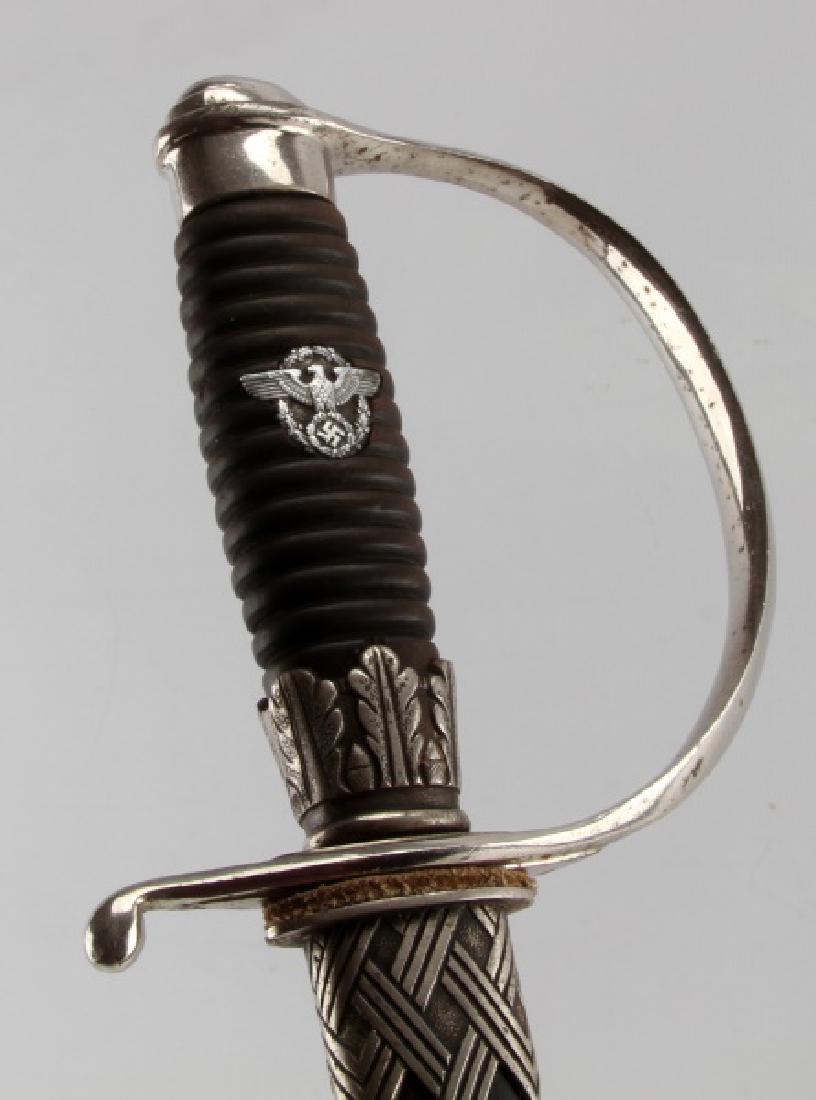 GERMAN WWII THIRD REICH POLICE NCO DEGAN EICKHORN: A Third Reich Police NCO Degen, created by Carl Eickhorn (Squirrel holding sword C.E. trademark). with SS stamped underside of the crossguard and on scabbard throat. Also has original style SS white l