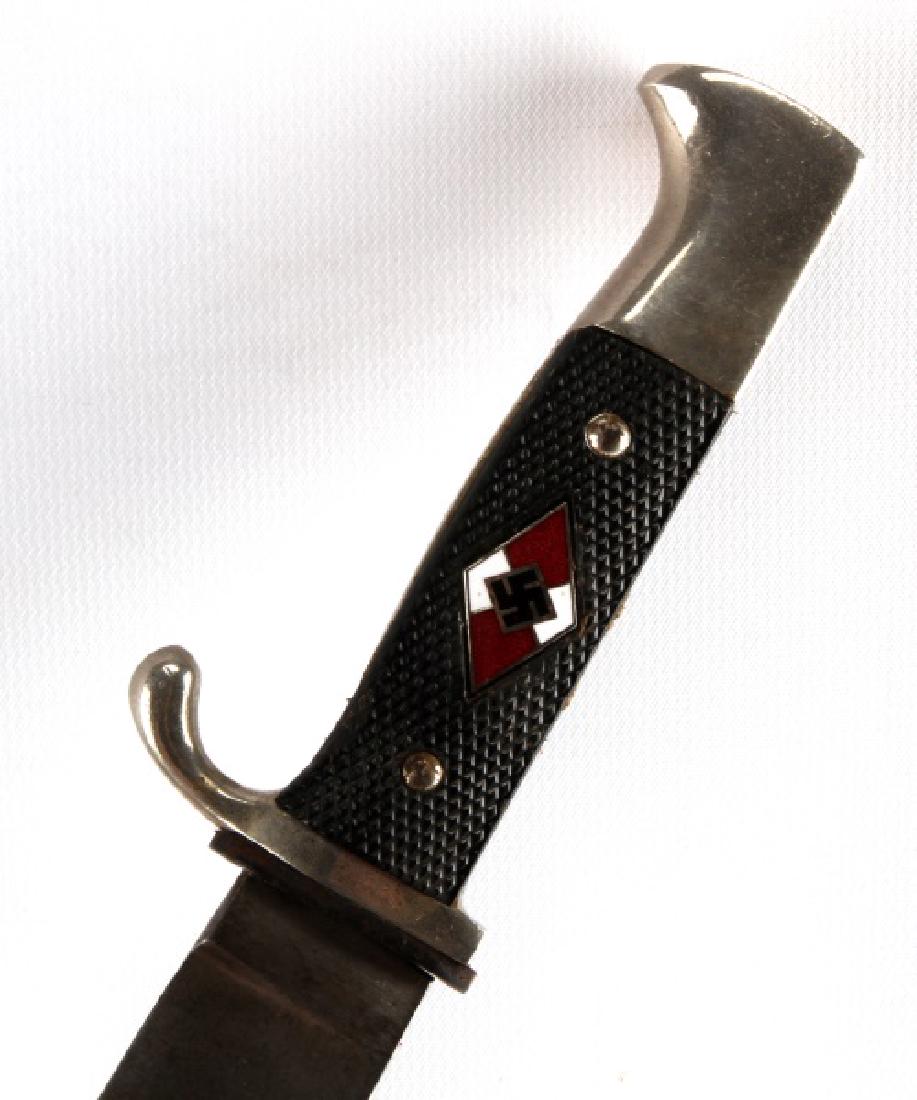 WWII GERMAN THIRD REICH HITLER YOUTH JUGEND KNIFE: Complete HJ diamond with full enamel, RZM M7/8 stamped blade, Bakelite grip, leather holder is torn, very good scabbard with moderate paint loss.