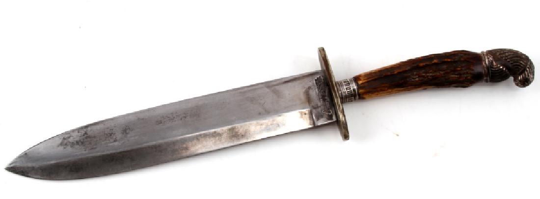 HARRISON BROS & HOWSON STAG HANDLE SHEFFIELD KNIFE: Antique dagger knife with leather scabbard. Measures 15 3/4" (9 5/8" blade). Single-sided blade has some tarnish. Good edge. Stag antler handle with silver accent to pommel. Ricasso of blade is maker 