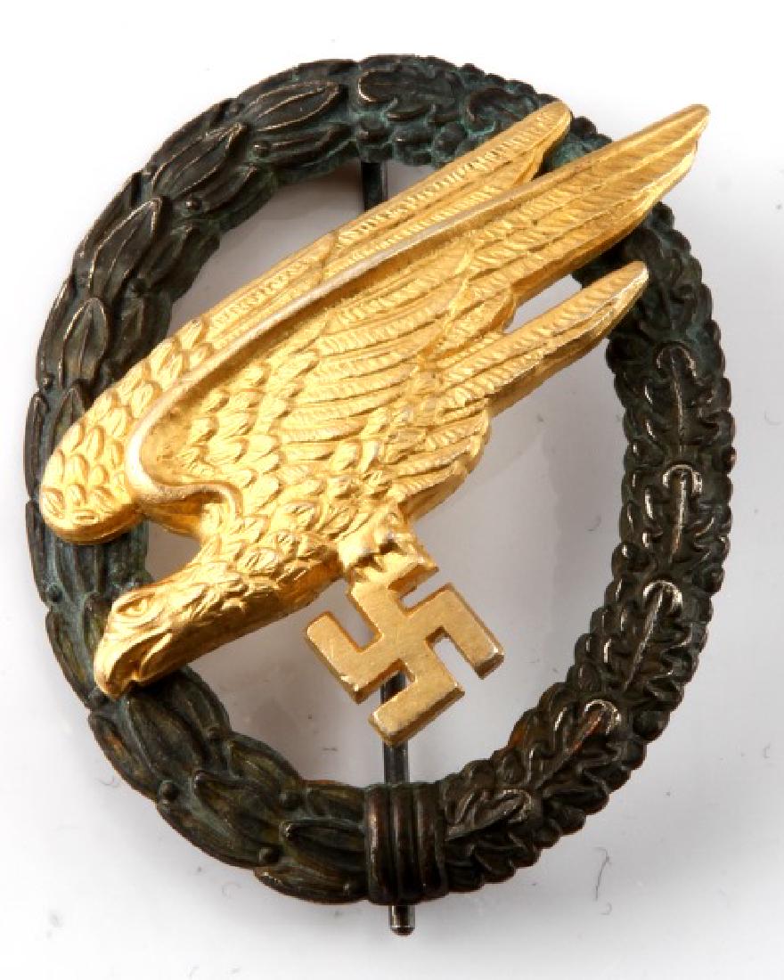 WWII GERMAN LUFTWAFFE PARATROOPER FALLSCHIRMJAGER: German WWII Luftwaffe Paratrooper Fallschirmjager Jump Badge. Maker marked 'G H Osang Dresden". Has thin vertical 'T' bar style pin back. Two piece, two domed rivet nickel and brass construction. Meas