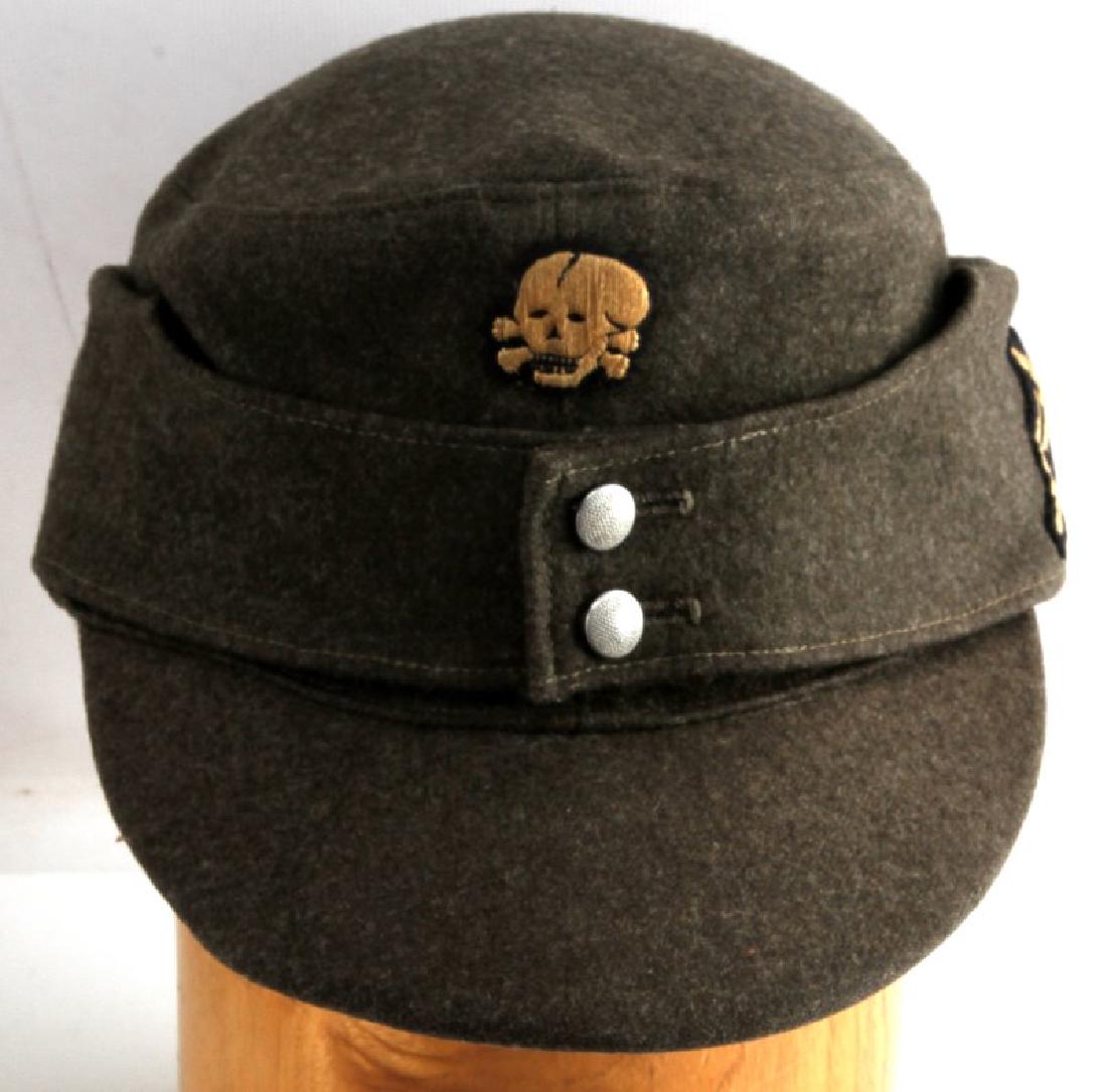 GERMAN WWII SS GEBIRGSJAGER MOUNTAIN TROOP M43 CAP: German WWII Gebirgsjager mountain troop M43 field cap. Features both Totenkopf and the mountain troops edelweiss flower insignia on side. Light soiling on interior rim from sweat/wear. Double buttons 