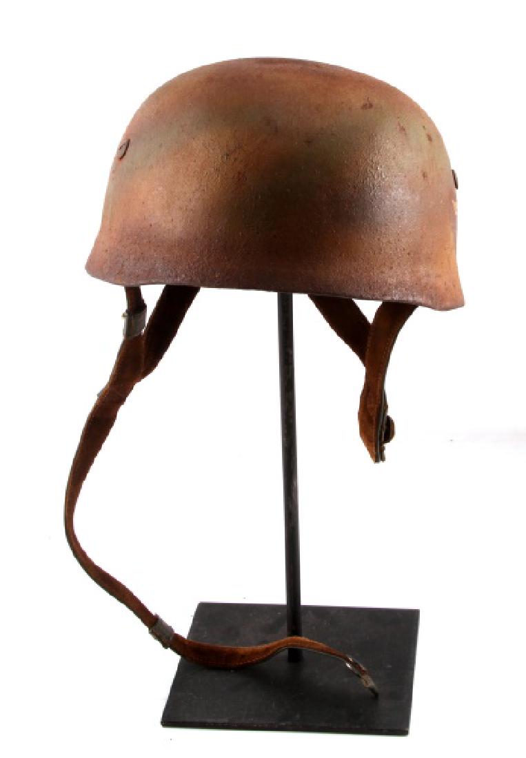 WWII LUFTWAFFE PAINTED PARATROOPER HELMET W LINER: Discoloring and wear present to interior. Rust and wear present to exterior. Interior leather liner bears maker stamp. Straps are untorn. Luftwaffe eagle is clean and crisp with relation to age. Overa